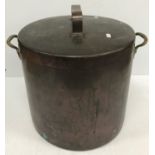 A large copper lidded cooking vessel with brass handles and initialled "DR" to side,