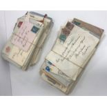 A box containing a collection of various postcards and stamped letters including twelve various