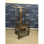 A Chinese ebonised pen work decorated scrolling floral and foliate design yoke back arm chair of