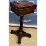 An early 19th Century rosewood teapoy of sarcophagus form,