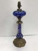 A late Victorian Bohemian blue overlaid glass and brass table oil lamp in the Rococo style,