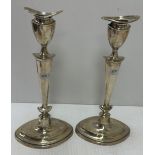 A pair of George V silver table candlesticks of navette form with loaded bases (by Elkington & Co,