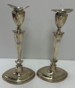 A pair of George V silver table candlesticks of navette form with loaded bases (by Elkington & Co,