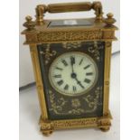 A circa 1900 French brass carriage clock with embossed leather face, inscribed "Déposé",