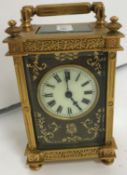 A circa 1900 French brass carriage clock with embossed leather face, inscribed "Déposé",