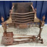 A 19th Century polished steel fire basket of serpentine shape with urn finials and raised on square