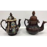 A collection of five treacle-glazed teapots including a 19th Century snuff taking Toby (x 2),