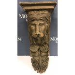 A painted lion mask and scrollwork wall bracket in the 19th Century style, 25.