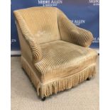 A late Victorian gold striped upholstered salon arm chair on turned ebonised front legs to brass