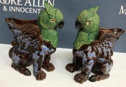 A pair of Victorian polychrome decorated and treacle-glazed gryphon vases with blue dragon