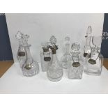 A collection of eight various glass decanters, two with silver mounts, one by Villeroy & Boch,