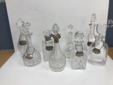 A collection of eight various glass decanters, two with silver mounts, one by Villeroy & Boch,