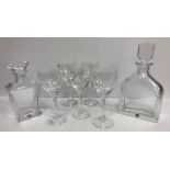 Two modern Orrefors decanters, a set of five Kosta Boda wine glasses, a glass handkerchief vase,