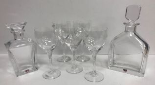 Two modern Orrefors decanters, a set of five Kosta Boda wine glasses, a glass handkerchief vase,
