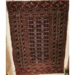 A Bokhara rug, the central panel set with three medallions on a red ground with tarantula motifs,