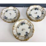 A collection of thirteen Limoges floral and gilt decorated plates to include one comport,