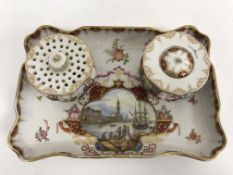 A circa 1900 Dresden porcelain ink stand of rectangular form with shaped edge decorated with panel