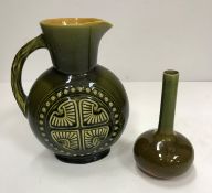 A Linthorpe pottery jug in the style of Christopher Dresser green glazed with Aztec motif