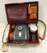 A Polaroid 10A camera in leather satchel type case