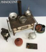 A miniature tin and enamelled stove 27.