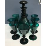 A Bristol green glass ring-necked mallet-shaped decanter and set of eight funnel-shaped wines (1