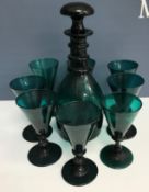 A Bristol green glass ring-necked mallet-shaped decanter and set of eight funnel-shaped wines (1