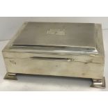 A modern silver cigarette box with engine-turned decoration,