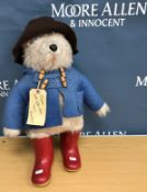 A 1972 Gabrielle Designs Ltd Paddington Bear in brown hat and blue coat 52 cm high together with a