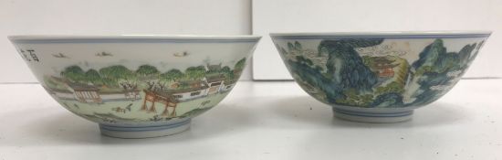 A pair of 20th Century Chinese polychrome landscape decorated bowls depicting a town scene with