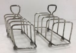 A pair of George V silver four section toast racks of offset rectangular or parallelogram form,