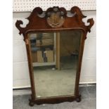 An 18th Century walnut fretwork carved wall mirror with Prince of Wales feather surmount over a