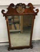An 18th Century walnut fretwork carved wall mirror with Prince of Wales feather surmount over a