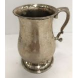 An Elizabeth II silver baluster shaped Christening mug bearing monogrammed initials "GAM" raised on