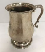 An Elizabeth II silver baluster shaped Christening mug bearing monogrammed initials "GAM" raised on