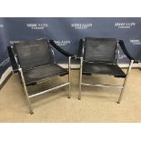 A pair of chrome framed LC1 chairs with faux leather back and seat and leather arm rests after the