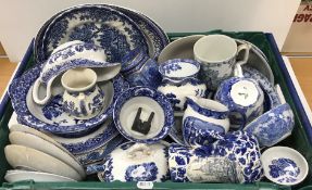 Two crates of assorted blue and white china to include "Willow" pattern wares,
