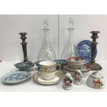 A box containing two modern glass decanters, a pair of silver plated candlesticks,