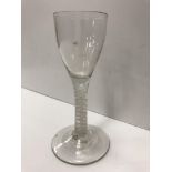 An 18th Century wine glass, the bucket shaped bowl on a white enamel twist stem to circular foot 13.