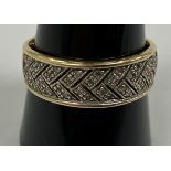 A 14 carat gold and diamond chip set dress ring with pierced chevron style pattern, size S/T, 3.