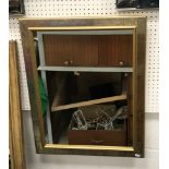 A 20th Century oval brass framed wall mirror with flaming torch and ribbon surmount over a bevel