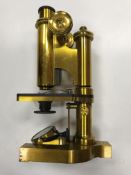 A circa 1900 lacquered brass cased monocular microscope by R & J Beck Ltd London No'd 21321 in
