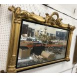 An early Victorian carved giltwood and gesso framed over mantel mirror with foliate and floral