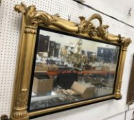 An early Victorian carved giltwood and gesso framed over mantel mirror with foliate and floral