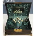 A 19th Century leather covered and lacquered brass embellished vanity case 29.