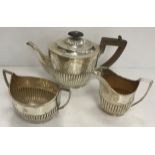 A Victorian silver three-piece tea set of oval form with semi-reeded decoration (Birmingham 1886),