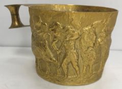 A Victorian silver gilt Arts & Crafts style mug with relief work decoration of cattle and figures