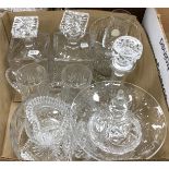 A box containing a quantity of cut and other glassware to include three decanters, vase, fruit bowl,