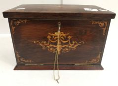 An Edwardian rosewood and inlaid desk top stationery cupboard,