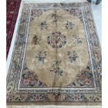 A Chinese superwash carpet, the central panel set with floral sprays on a beige ground,