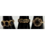 A collection of three 9-carat gold dress rings, one set with three garnets,